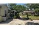Paver patio with string lights and view of the house and screened porch in the backyard at 1372 Palmetto St, Clearwater, FL 33755
