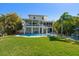 Expansive backyard featuring a refreshing swimming pool and lush lawn, ideal for outdoor enjoyment at 14554 90Th Ave, Seminole, FL 33776