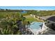 Aerial view of a private backyard with a pool, lush greenery, and water views at 14554 90Th Ave, Seminole, FL 33776