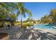 Backyard featuring a kidney-shaped pool, lush tropical landscaping, and outdoor seating area at 14554 90Th Ave, Seminole, FL 33776