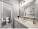 Bright bathroom featuring a white vanity with quartz countertop and a walk-in shower at 14554 90Th Ave, Seminole, FL 33776