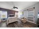 Stylish bedroom with a modern ceiling fan, wood floors, and an abundance of natural light at 14554 90Th Ave, Seminole, FL 33776