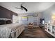 Stylish bedroom with a modern ceiling fan, wood floors, and an abundance of natural light at 14554 90Th Ave, Seminole, FL 33776