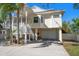 Charming elevated home featuring an attached two-car garage and inviting staircase at 14554 90Th Ave, Seminole, FL 33776