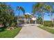 Stunning elevated home featuring a long drive, ample parking, and lush landscaping at 14554 90Th Ave, Seminole, FL 33776