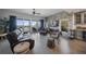 The living room features stone accent wall, fireplace, and access to a balcony with scenic views at 14554 90Th Ave, Seminole, FL 33776