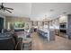 Open-concept living room showcases a brick accent wall with fireplace and a modern kitchen with island seating at 14554 90Th Ave, Seminole, FL 33776