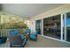 Relax on this covered patio with cozy seating around a fire pit, and enjoy a view of the home's interior at 14554 90Th Ave, Seminole, FL 33776