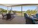 This covered patio features comfortable seating and a table perfect for outdoor dining and entertaining with water views at 14554 90Th Ave, Seminole, FL 33776