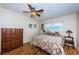 Bedroom with ceiling fan, hardwood floors, window, and dresser at 3010 59Th S St # 303, Gulfport, FL 33707