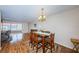 Dining room with hardwood floors, chandelier and view into living room at 3010 59Th S St # 303, Gulfport, FL 33707