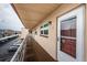 Hallway view of condo unit 303 with a storm door, building number, and view of the parking lot at 3010 59Th S St # 303, Gulfport, FL 33707