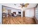 Open concept living room with hardwood floors, fan and view into dining room at 3010 59Th S St # 303, Gulfport, FL 33707