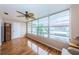 Sun room with hardwood floors, fan and many windows at 3010 59Th S St # 303, Gulfport, FL 33707