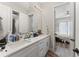 Bright bathroom with double sinks, quartz countertops, and a view of the bedroom and shower at 4142 N Nebraska Ave, Tampa, FL 33603