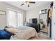 Bright bedroom with a ceiling fan, modern black dresser, and a full-length mirror at 4142 N Nebraska Ave, Tampa, FL 33603