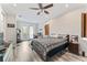 Spacious bedroom with ceiling fan, wood floors, and sliding doors to a private balcony at 4142 N Nebraska Ave, Tampa, FL 33603