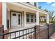 Charming covered entrance with classic columns and black metal fence detailing at 4142 N Nebraska Ave, Tampa, FL 33603