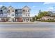 Modern townhome exterior with a mix of brick and siding, and a black metal fence at 4142 N Nebraska Ave, Tampa, FL 33603