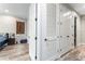 Bright hallway with neutral walls and wood-look floors, showcasing a glimpse of a bedroom at 4142 N Nebraska Ave, Tampa, FL 33603