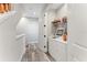 Hallway with laundry nook, neutral walls, wooden floors, and a built-in display shelf at 4142 N Nebraska Ave, Tampa, FL 33603