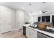 Open-concept kitchen with white cabinets, stainless steel appliances, a center island, and views into the living area at 4142 N Nebraska Ave, Tampa, FL 33603