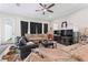 Inviting living room featuring hardwood floors, neutral tones, lots of seating, and a ceiling fan at 4142 N Nebraska Ave, Tampa, FL 33603