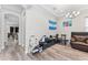 View through archway to cluttered living room with brown leather sofa at 4142 N Nebraska Ave, Tampa, FL 33603