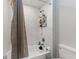 Clean and modern shower with white marble tile and built-in shelving for bath products at 4142 N Nebraska Ave, Tampa, FL 33603