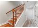 Wooden staircase featuring white risers and wood-look flooring. Natural light accents the staircase at 4142 N Nebraska Ave, Tampa, FL 33603