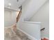 Classic wooden staircase with white risers and modern wood-look flooring leads to the upper level of the home at 4142 N Nebraska Ave, Tampa, FL 33603