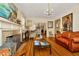 Open-concept living room featuring hardwood floors, a fireplace, and a chandelier at 417 W Davis Blvd, Tampa, FL 33606