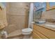 Tiled bathroom with a walk-in shower with a seat and a granite countertop vanity with a sink at 4215 E Bay Dr # 105, Clearwater, FL 33764