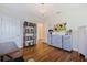 Well-lit office area featuring hardwood floors, a sunflower painting, and decorative cabinet at 4545 6Th N Ave, St Petersburg, FL 33713