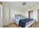 Cozy bedroom with wood floors, a decorative light fixture, and a blue patterned bedspread at 750 N Tamiami Trl # 1203, Sarasota, FL 34236