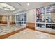 Hallway with glass-enclosed view of the gym at 750 N Tamiami Trl # 1203, Sarasota, FL 34236