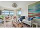 Bright living room boasts amazing water views, designer furnishings and colorful art at 750 N Tamiami Trl # 1203, Sarasota, FL 34236