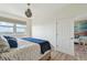 Comfortable bedroom features a view, wood-look floors, and neutral decor at 750 N Tamiami Trl # 1203, Sarasota, FL 34236