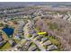 Aerial view of a single-Gathering home in a lush neighborhood near a body of water at 8419 May Port Ct, Land O Lakes, FL 34638