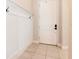 A clean entryway featuring light tile floors, white paneled wainscoting and a white front door at 8419 May Port Ct, Land O Lakes, FL 34638