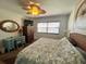 Bedroom featuring a nautilus art theme, ceiling fan, and stylish coastal furniture at 880 Mandalay Ave # S1014, Clearwater Beach, FL 33767