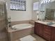 The bathroom includes an oval tub, a walk-in shower, and a sink at 920 Regal Manor Way, Sun City Center, FL 33573