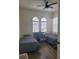 Bright bedroom featuring two twin beds, a desk, and large windows that bring in natural light, all with wood floors at 920 Regal Manor Way, Sun City Center, FL 33573
