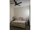 Bedroom with ceiling fan features neutral walls, and a queen bed with decorative pillows, perfect for relaxation at 920 Regal Manor Way, Sun City Center, FL 33573