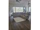 Spacious living room with a large sectional sofa, wood flooring and sliding glass doors to the screened patio at 920 Regal Manor Way, Sun City Center, FL 33573