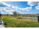 A spacious backyard with a scenic view of the water and surrounding community, with a full black fence at 12515 Horseshoe Bend Dr, Lithia, FL 33547
