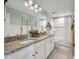 Bathroom with a large mirror, granite countertop, dual sinks and a shower/tub combination at 12515 Horseshoe Bend Dr, Lithia, FL 33547