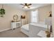 Bright bedroom featuring neutral walls, ceiling fan, light carpet, and a white bed set below a window at 12515 Horseshoe Bend Dr, Lithia, FL 33547