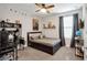 Comfortable bedroom with a dark bed frame, desk, and window with curtains at 12515 Horseshoe Bend Dr, Lithia, FL 33547