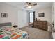 Cozy bedroom with a colorful bedspread, dresser, and window for natural light at 12515 Horseshoe Bend Dr, Lithia, FL 33547